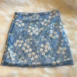 Beautiful blue skirt. Floral design, with a net finishing.